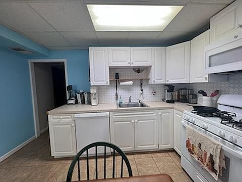Kitchen and can see hallway that leads to bedroom and living room