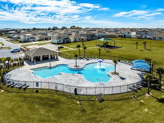 Resort-style pool with splash feature, cabana, and plenty of room to unwind.