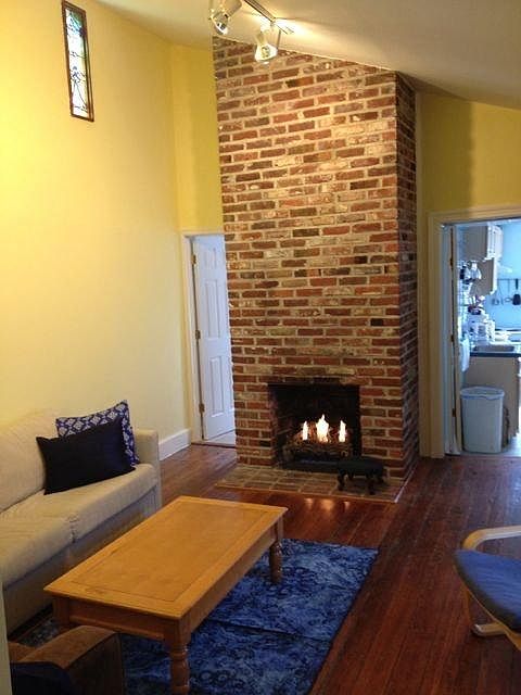 Living room view of gas fireplace and entrance to bathroom a