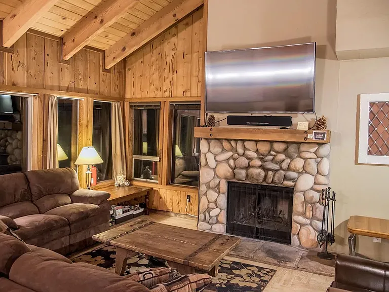 Living room with new TV and wood fireplace