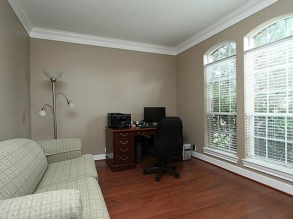 The formal living is being used as a study and carries the crown moulding for an elegant look.