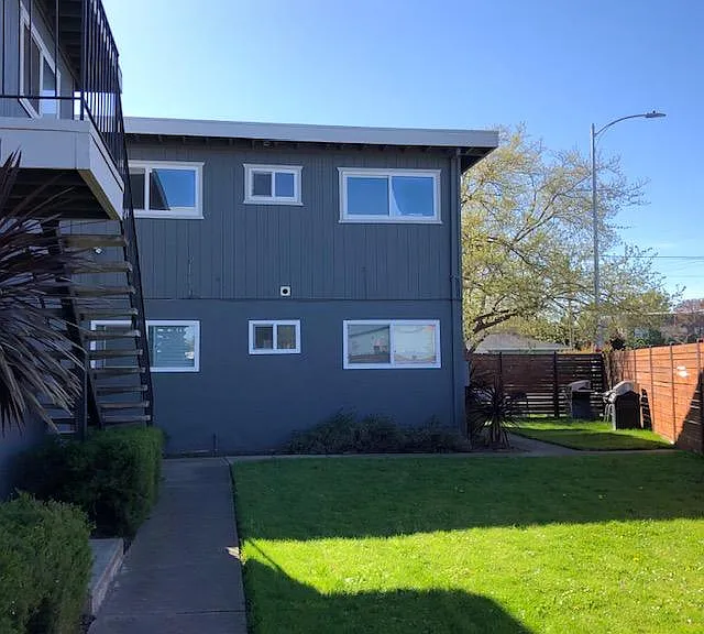 Side yard is a fenced shared common space for all six units for outdoor cooking.