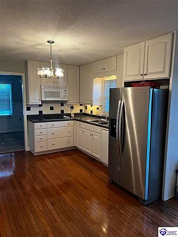 Smooth surface cooktop, microwave, dishwasher, refrigerator and lots of cabinets.