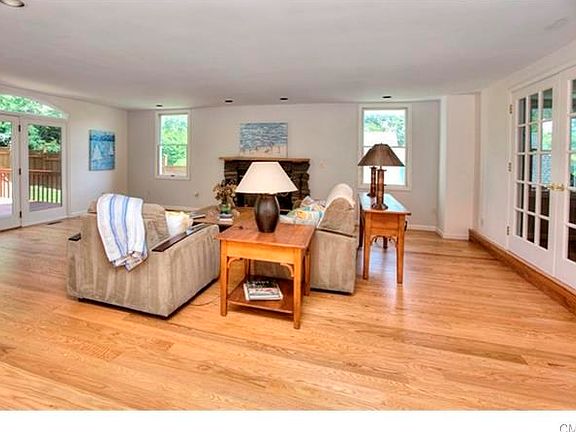 Family Room with wood burning Fireplace, atrium door to Deck, and French Doors on right to Office or 5th Bedroom.