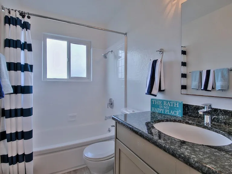 Updated bathroom with granite countertops and travertine tile floors