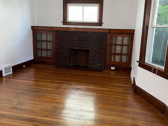 Living room. Well lit. gas fireplace and access to front porch.