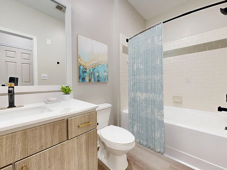 Full bathroom with ample storage and oversized soaking tub at Waterstone at Big Creek apartments for rent in Alpharetta, GA