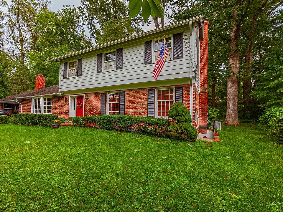 Front of the home with entry to the apartment to the right.