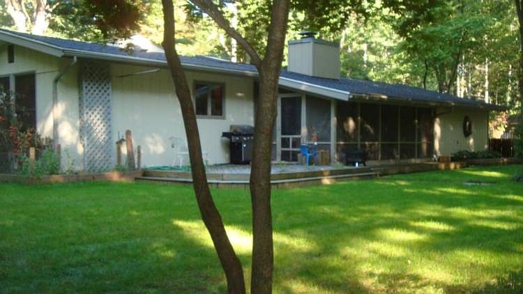 Family-friendly patio and screened porch is a perfect space for entertaining.  The irrigation system will keep the lawn looking this great all summer.