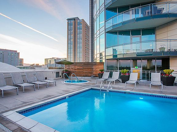 Swimming pool and sundeck with lounge seating.