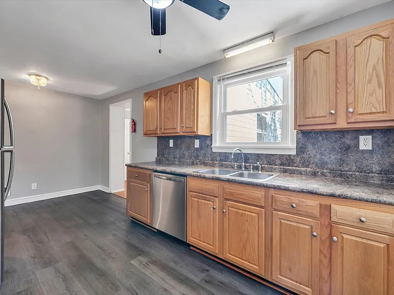 Spacious Kitchen w/ Ceiling Fan and Stainless Steel Appliances! Blinds Provided by Landlord!