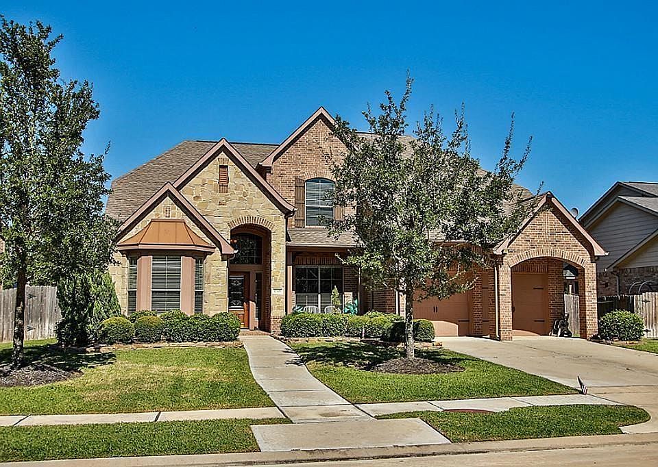 Home With Great Curb Appeal With Stone Accents To The Brick That Is On All 4 Sides. Metal Cap Over Bow Window Of The Study.
