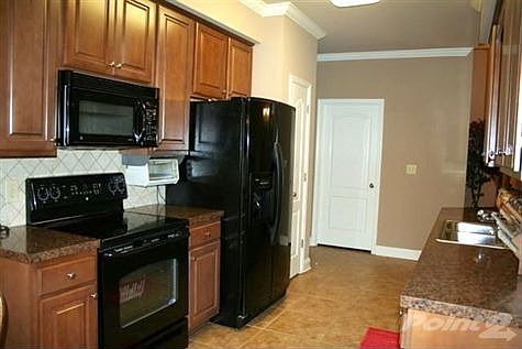 Kitchen with Pantry and Tile Backsplash