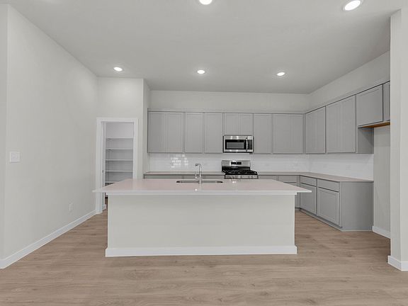 Kitchen in the Pecos home plan by Trophy Signature Homes - REPRESENTATIVE PHOTO