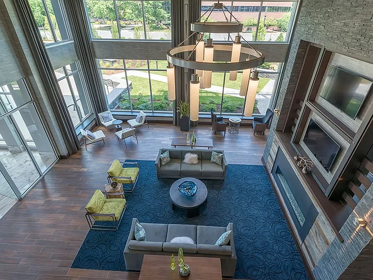 Dramatic clubroom with resident lounge, fireplace and flat screens