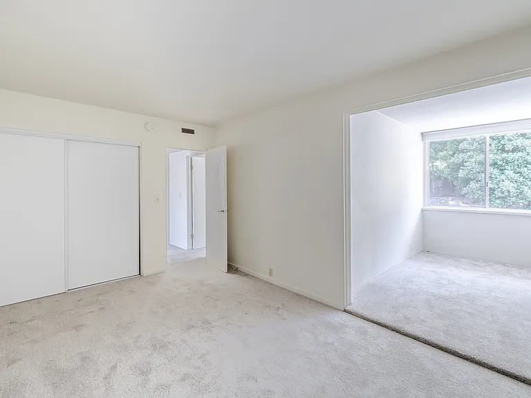 Oversized windows invite abundant natural light, creating a bright and tranquil atmosphere in Bedroom C.