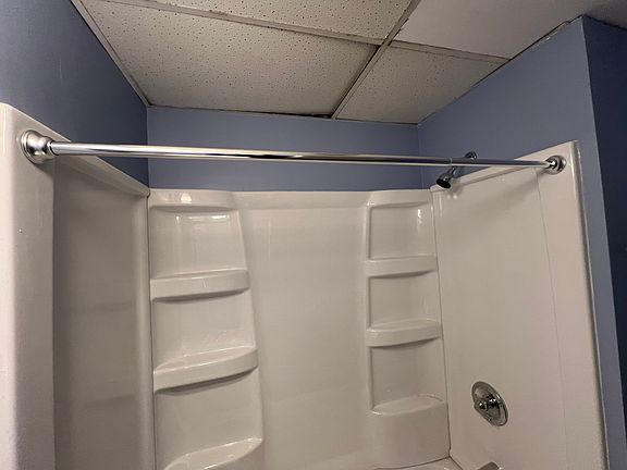 Complete bathroom renovation with new tub and fixtures, new vanity, paint, and new flooring.