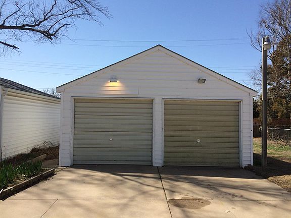 Large garage with electric openers. Work bench and refriger