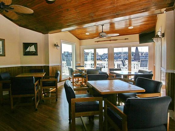 A portion of the clubhouse/bar and view fo the harbor. It looks right over the pool and harbor. It is located about 50 yards from the condo.