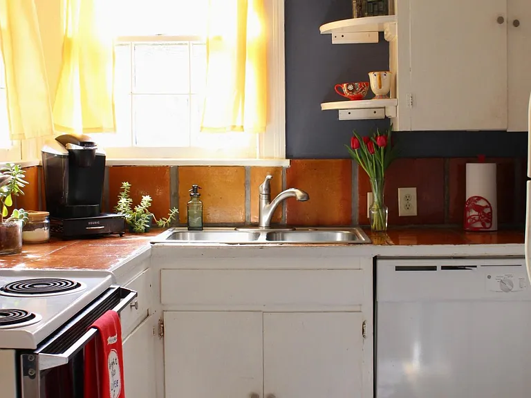 Pretty kitchen with tile and new sink, faucet and dishwasher.