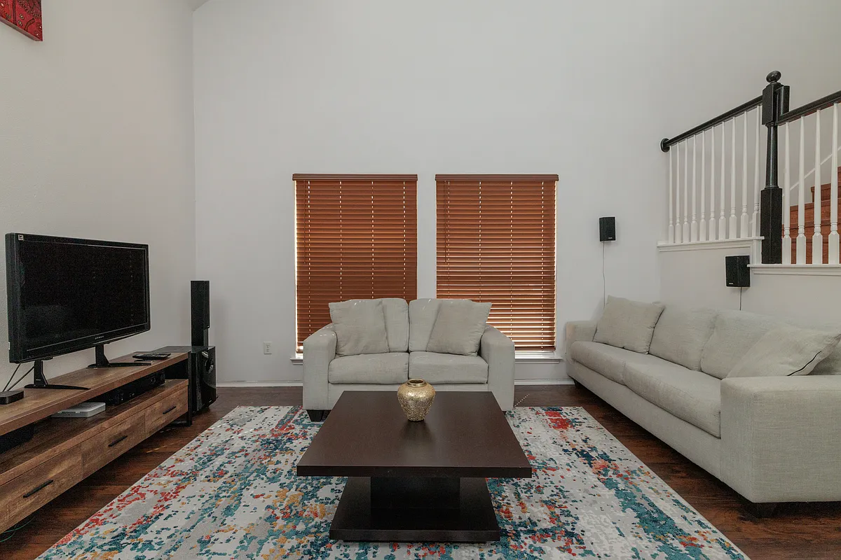 Spacious living room with couch, love seat and TV. - 213 Patriot Ln