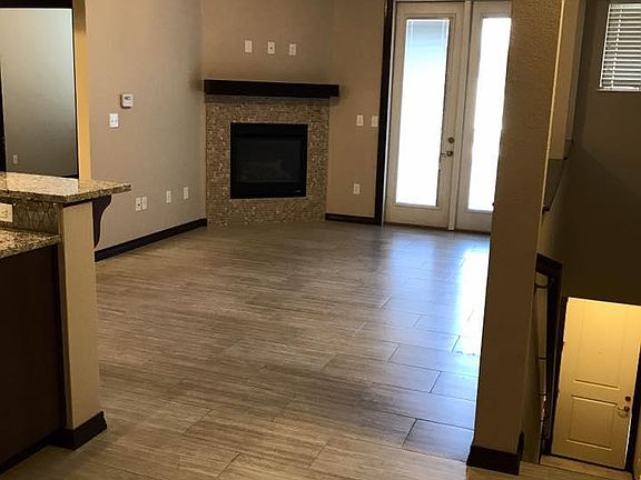 Living room featuring vaulted ceilings and a gas fireplace 