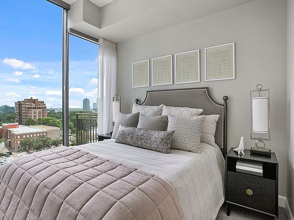A serene bedroom retreat filled with natural light, featuring expansive windows, inviting textures, and a thoughtfully designed space for rest and recharge