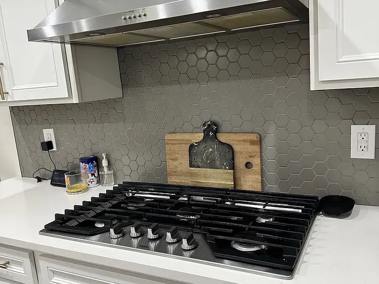 Five-burner stove with exterior-vented exhaust