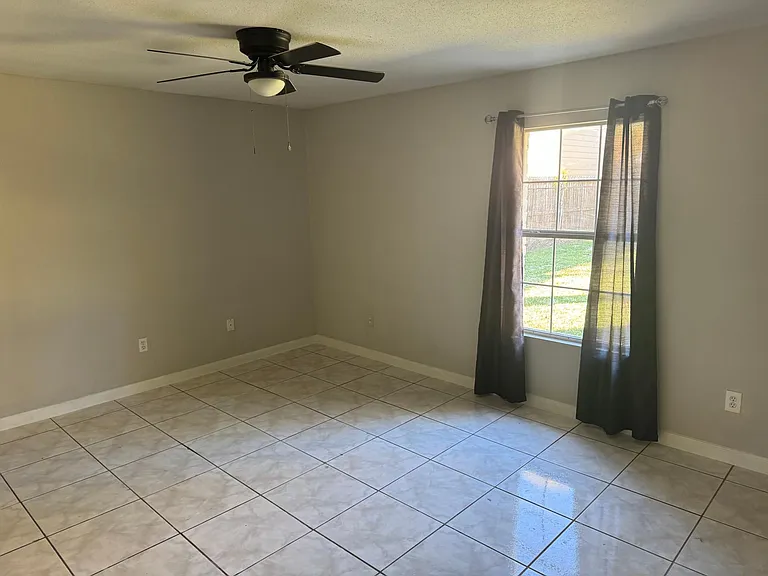This spacious primary bedroom is able to fit a king sized bed with window facing the back yard. Walk in closet and primary bath.