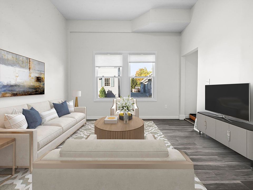 Large living area with oversized windows. (Unit is leased unfurnished)