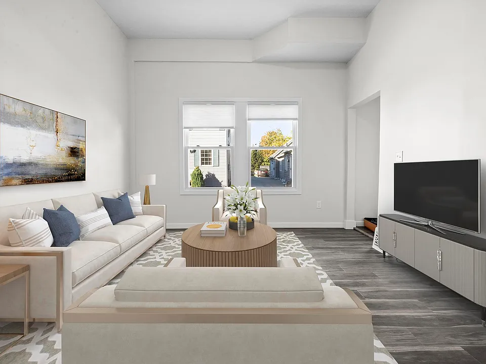 Large living area with oversized windows. (Unit is leased unfurnished)