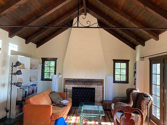 cathedral ceiling in living room with gas fireplace and decorative ironwork.