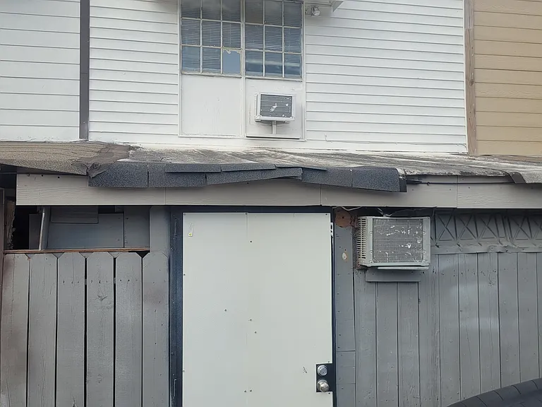 Back entrance of house, directly across from the entrance is covered parking space