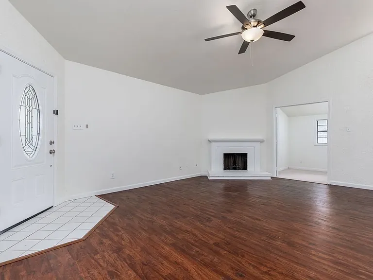 View of living room showing front door on the left and bonus room