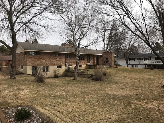 Large, private backyard with brick fireplace.