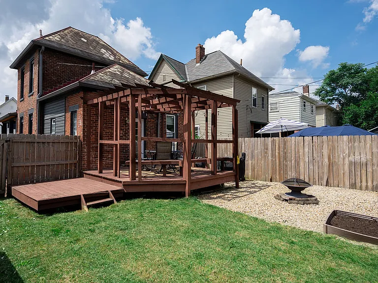 Fenced in backyard w/ deck