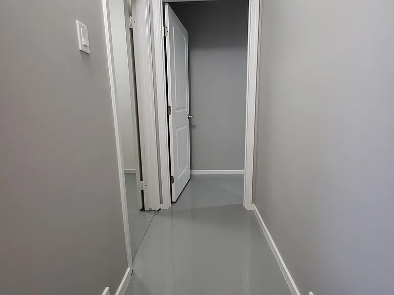 Hallway to Utility Room and Bedroom #3. New paint and Epoxy flooring - easy to clean.