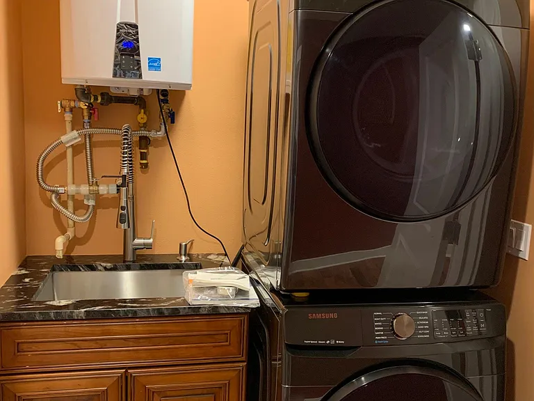 Washer and dryer closet with a deep sink.