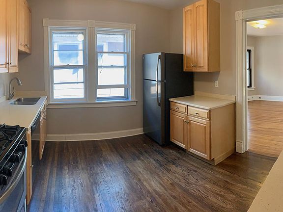 Kitchen - dishwasher, gas stove, fridge, quartz countertop with undermount sink (nice for sweeping crumbs from countertop). Door leads to dining room.