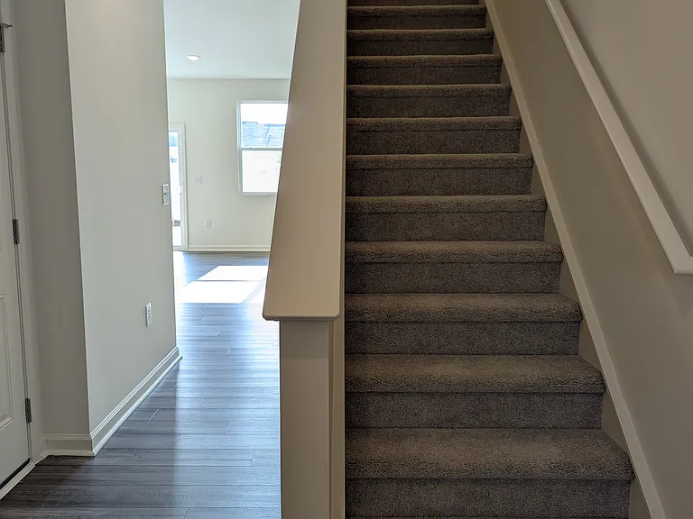 Entry way to kitchen on the left and upstairs to 3 bedrooms, 2 full bathrooms and laundry closet with washer and dryer included!