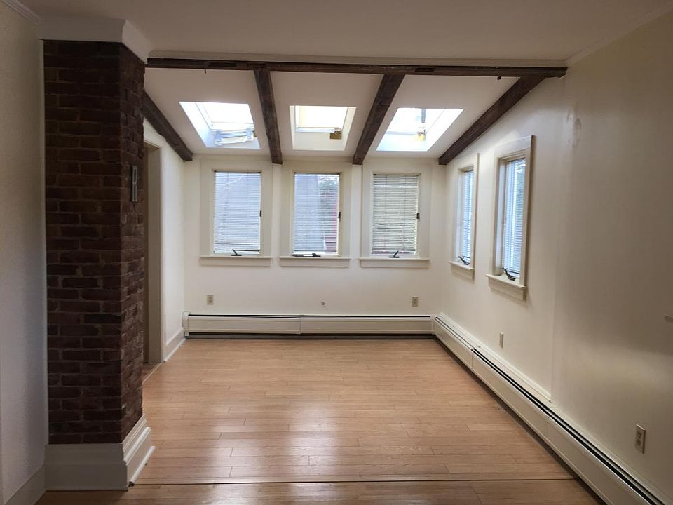 Exposed brick, skylights, and sun-drenched living area.