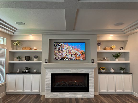 Great room with built in shelves and cabinets