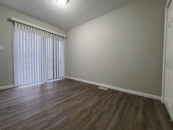 Main bedroom with sliding glass door viewing to back yard