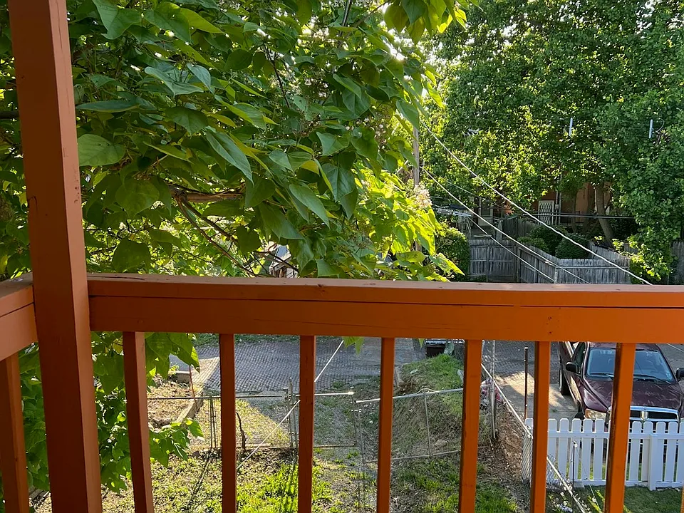 Private upper-level deck space with tree-lined view