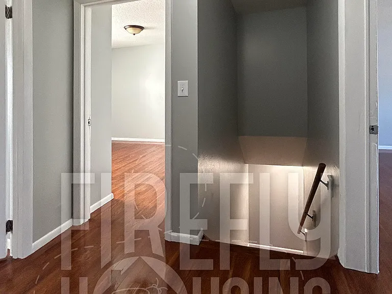 Upstairs Hallway at top of the Stairway with newly refinished floors in all upstairs rooms.