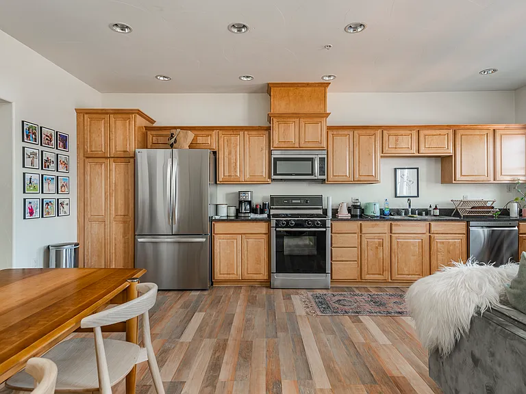 Open-concept kitchen with high-end appliances, quality cabinetry, and ample storage space,