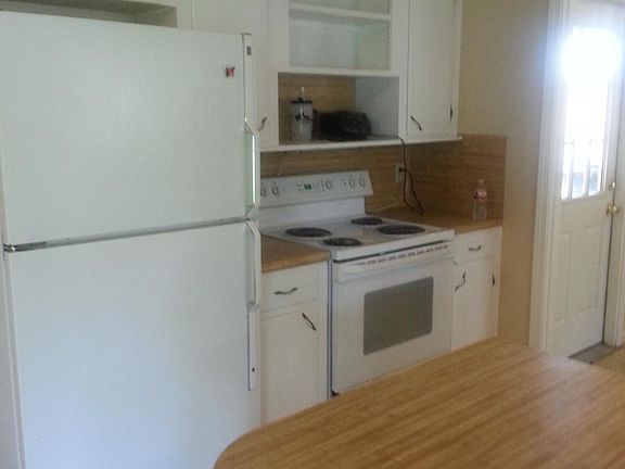 Kitchen, carport door leads into laundry room