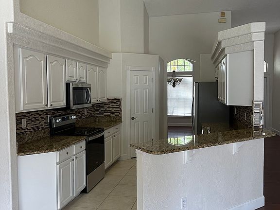 Kitchen with stainless appliances and granite counters.