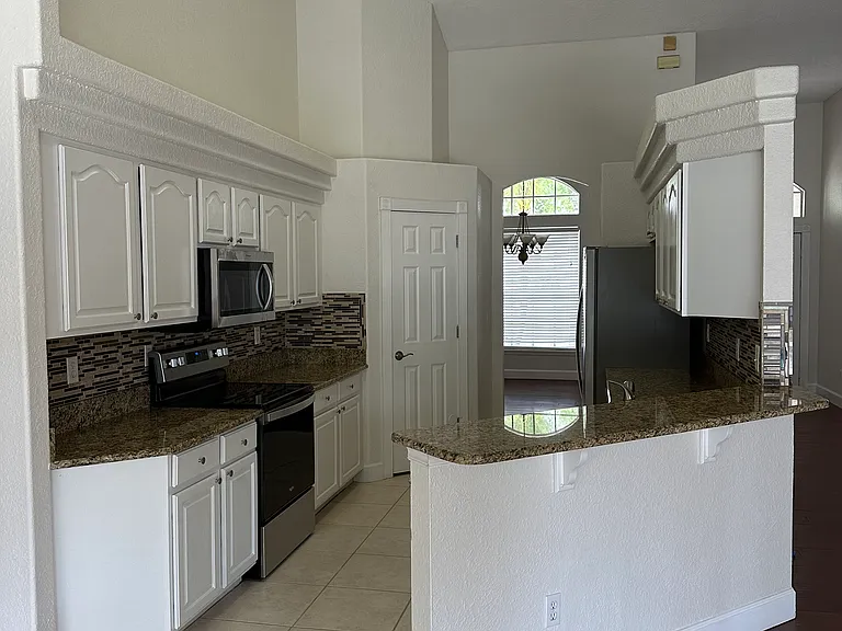 Kitchen with stainless appliances and granite counters.