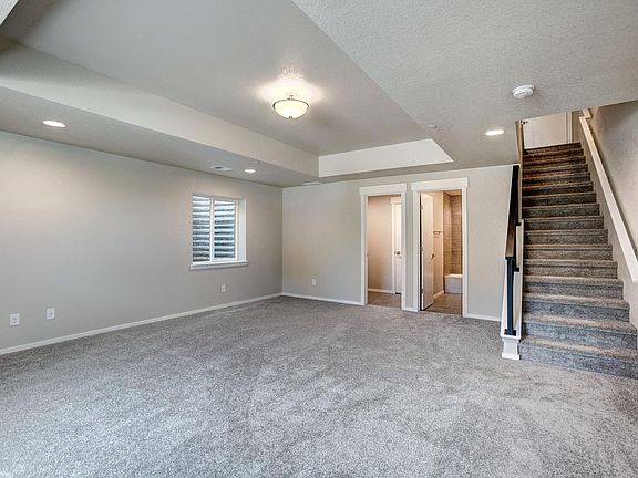 Basement living area, full bath, and laundry